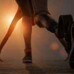 Back view of disabled athlete woman with prosthetic leg