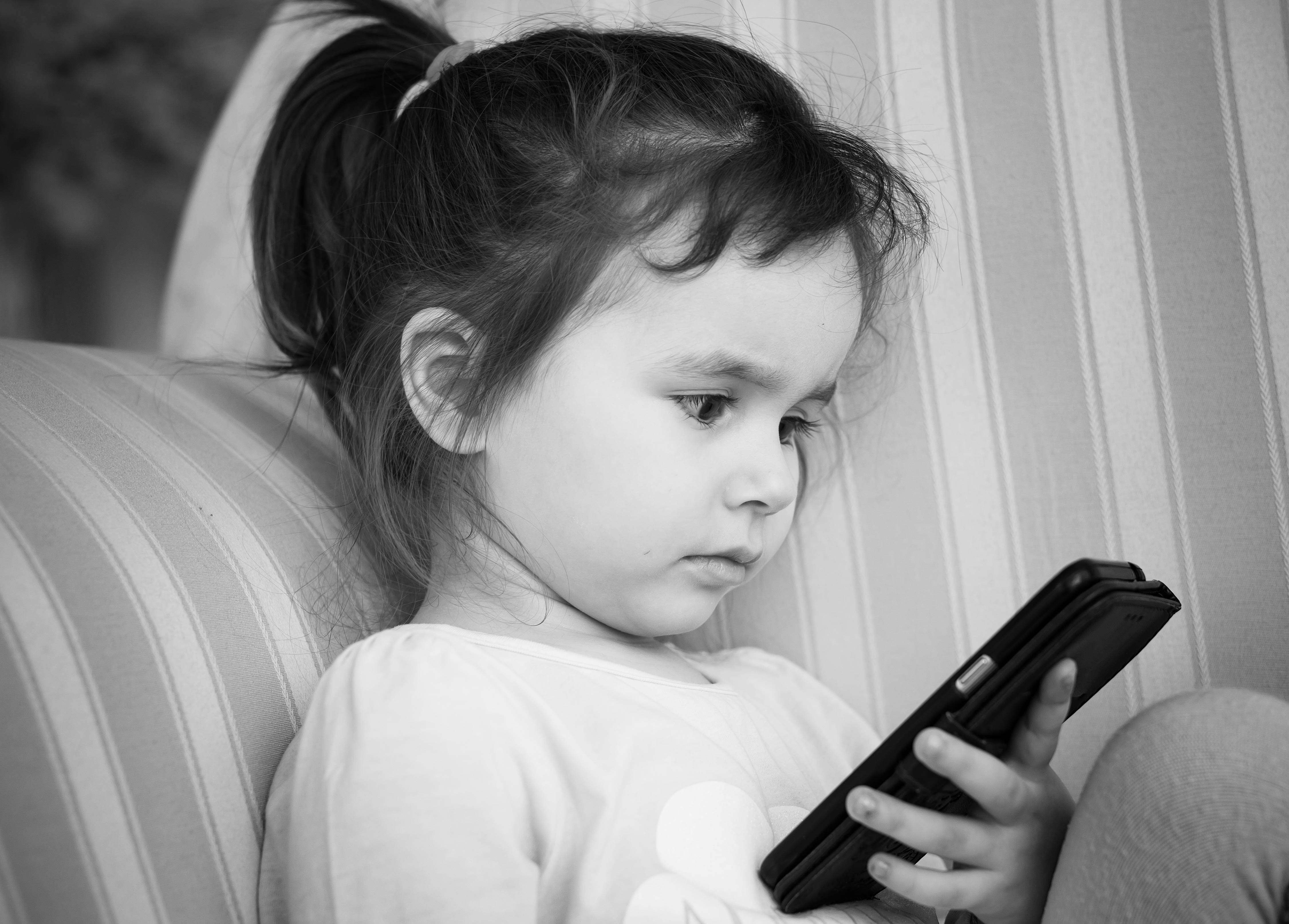 little child using smartphone