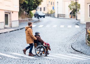 father in wheelchair and young son on a walk.