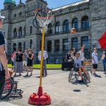 wheelchair user playing basket ball in the street