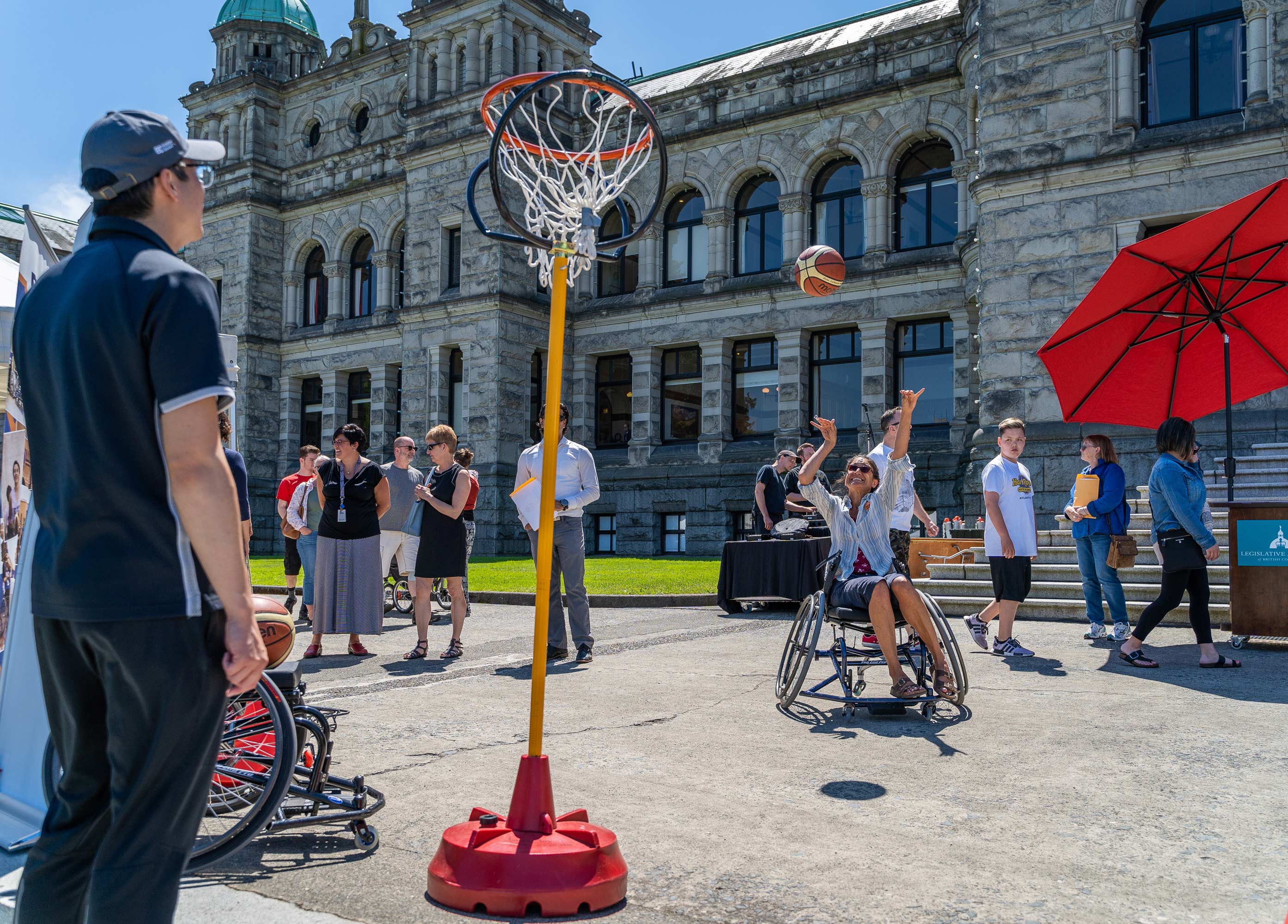 wheelchair user playing basket ball in the street