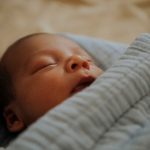 Infant baby fast asleep on the bed