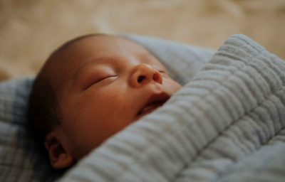Infant baby fast asleep on the bed