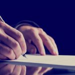 Close up Human Hand Signing on Formal Paper