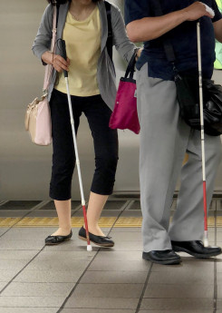 two blind people walking at the platform