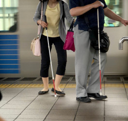two blind people walking at the platform