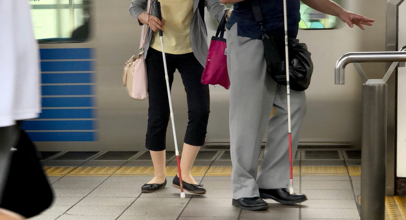 two blind people walking at the platform