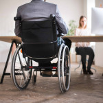 business man in wheelchair in the office.