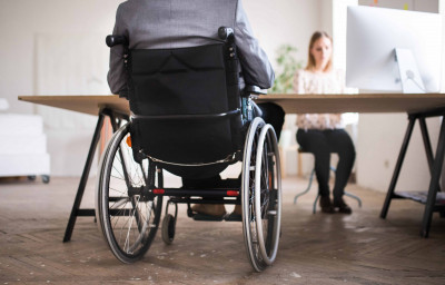 business man in wheelchair in the office.
