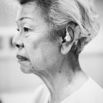 An elderly woman with hearing aid