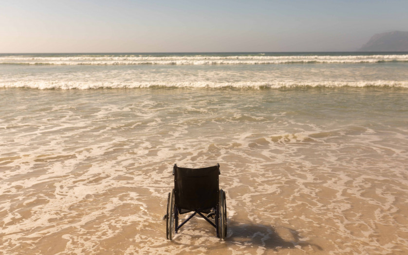 Rear view of empty wheelchair at seashore