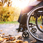 woman in wheelchair in autumn nature.