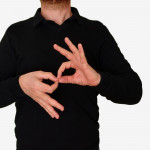 Sign language interpreter man translating a meeting to ASL