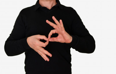 Sign language interpreter man translating a meeting to ASL