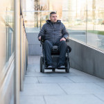 Man in a electric wheelchair using a ramp