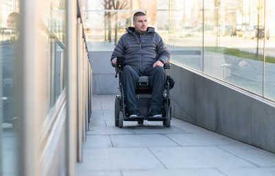 Man in a electric wheelchair using a ramp