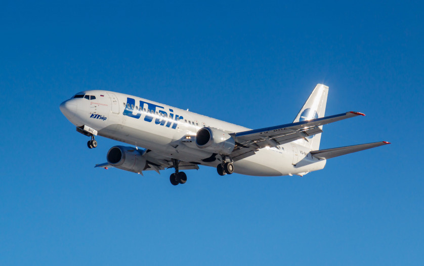 Aircraft Boeing 737-46M VQ-BHZ of UTair Aviation against blue sky in sunny morning