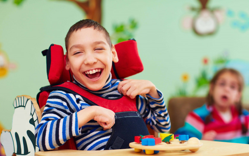 cheerful boy with disability at rehabilitation center