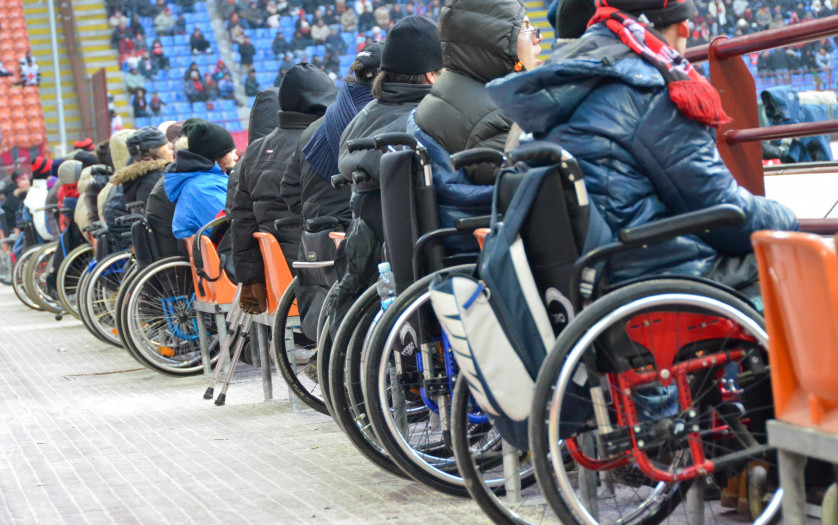 Football fan in wheelchair watching the match