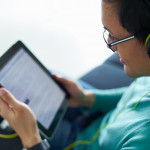 Man With Green Headphones Listens Podcast Tablet PC