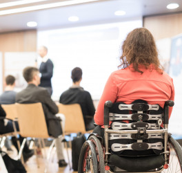 woman on wheelchair attending the conference