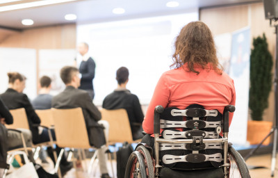 woman on wheelchair attending the conference