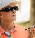 blind man using voice command on smartphone