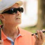 blind man using voice command on smartphone