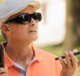 blind man using voice command on smartphone