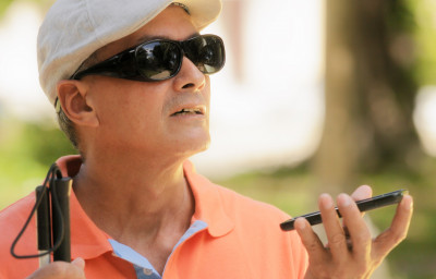 blind man using voice command on smartphone