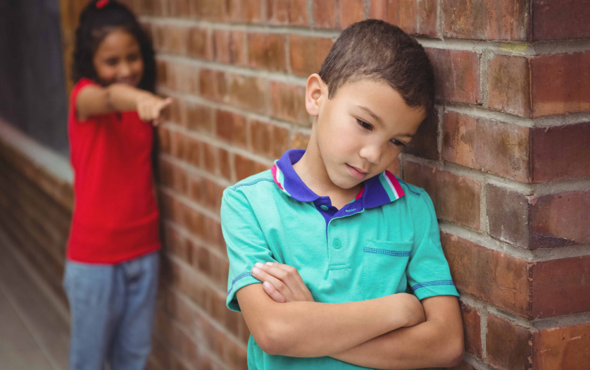 upset child being teased by classmate