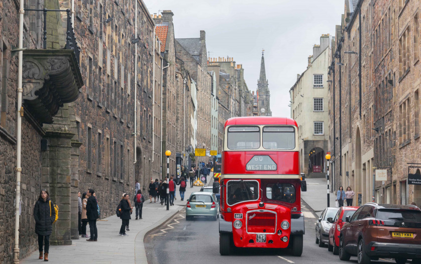 Classic red bus on a old road in Edinburgh, Scotland