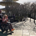man pushing woman in wheelchair