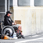 man in wheelchair in the street