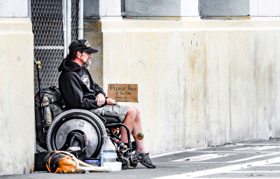 man in wheelchair in the street