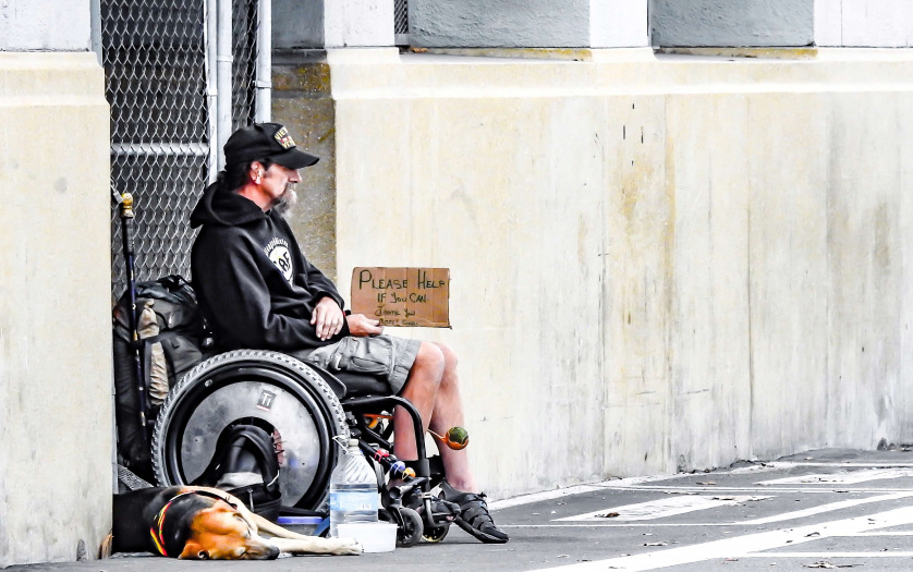 man in wheelchair in the street