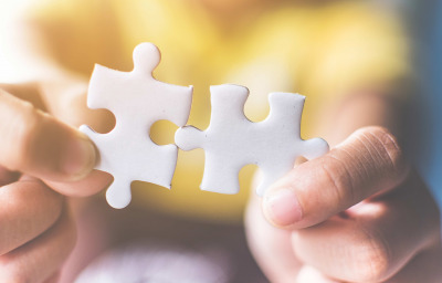 Hand connecting jigsaw puzzle