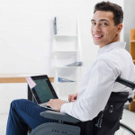 man in wheelchair working