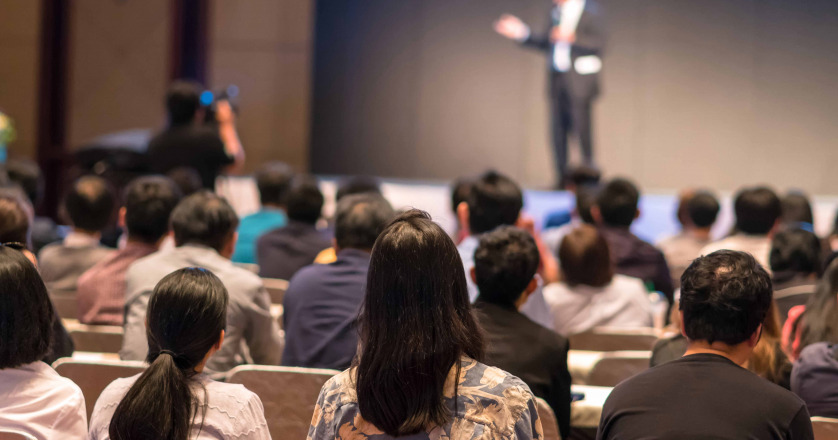 rear side audiences sitting listening speackers stage