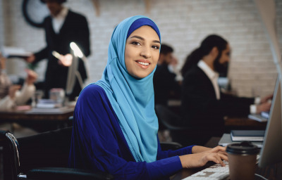 Arabian lady in wheelchair working