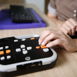 Blind person using audio book player listening to audio book on his computer.