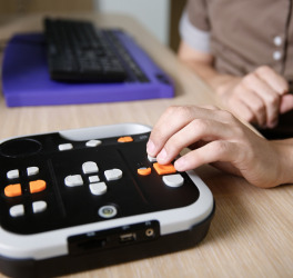 Blind person using audio book player listening to audio book on his computer.