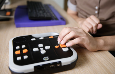 Blind person using audio book player listening to audio book on his computer.