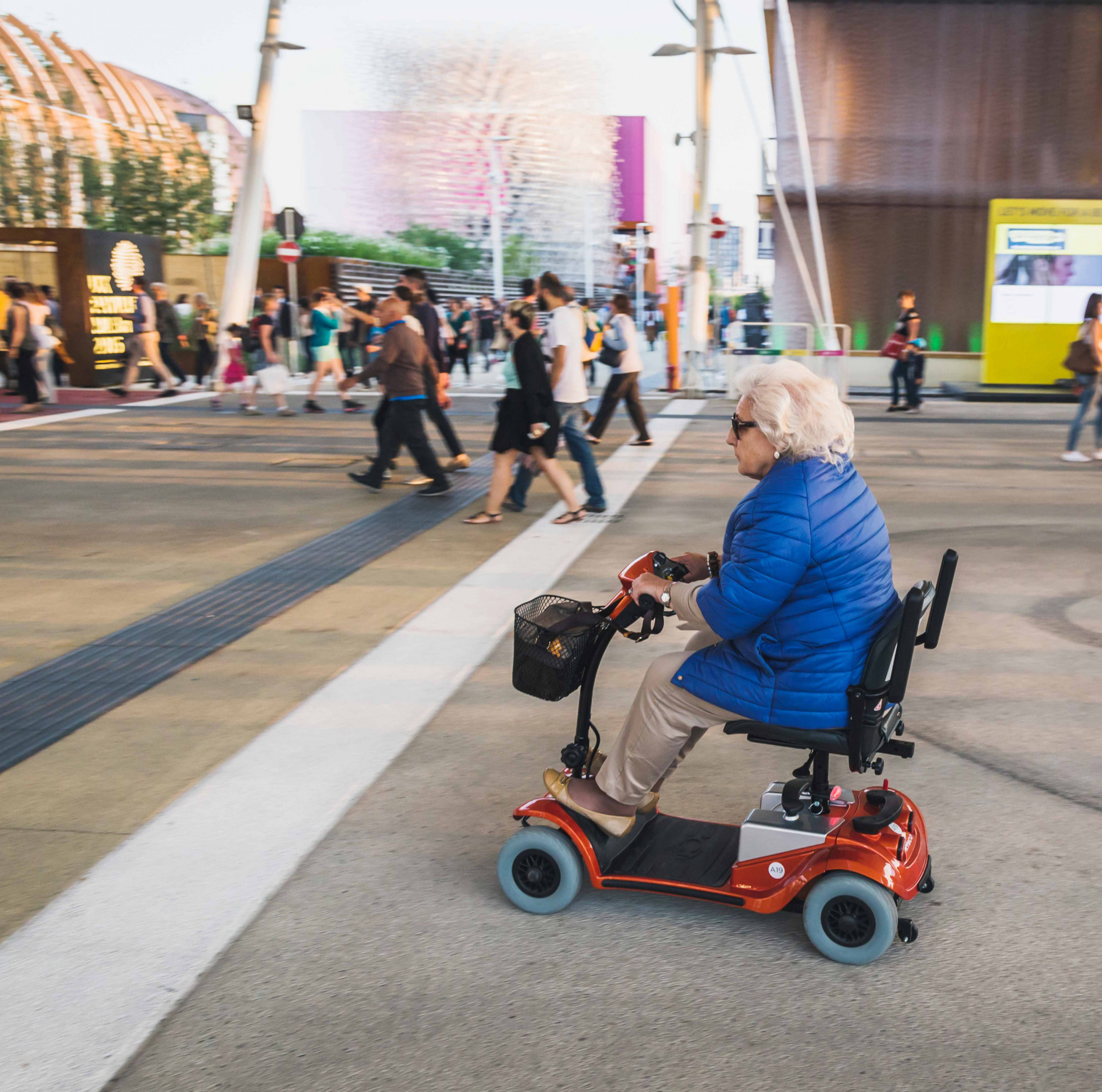 Elderly woman on electric mobility scooter at Expo