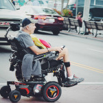 Man crossing road in wheelchair