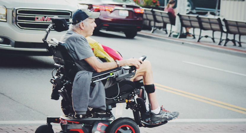 Man crossing road in wheelchair