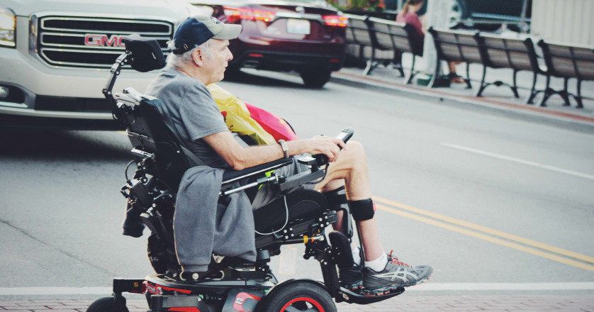 Man crossing road in wheelchair