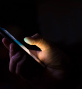 person texting in dark
