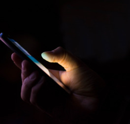 person texting in dark