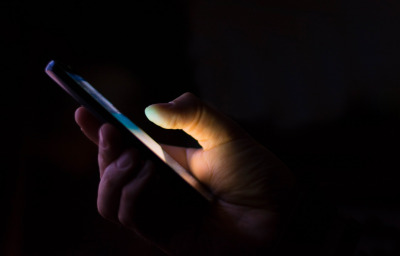 person texting in dark